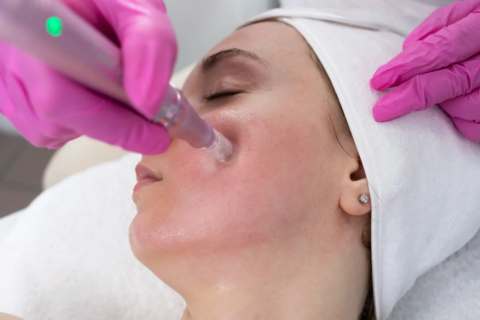A practitioner performing a professional facial treatment
